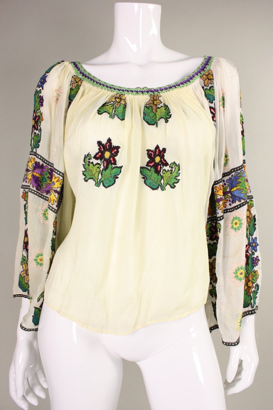 Museum-quality 1930's Eastern European blouse has bold, floral hand-embroidery down the sleeves and on the front of the blouse. Made of a cream-colored cotton gauze.  Unlined.  No closures.

Measurements

Bust: up to 36