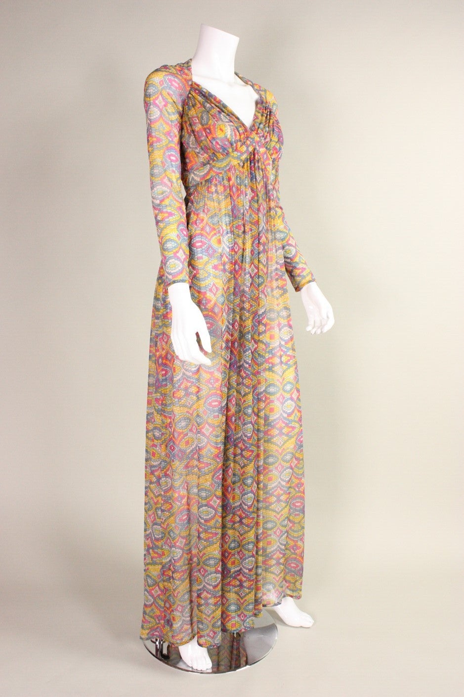 Vintage dress from Robert David-Morton dates to the 1970's and is made of a very lightweight synthetic jersey.  Fabric has multicolored geometric print.  Angular neckline echoes the print.  Rushed bust and under bust.  Lined only in front bust. 