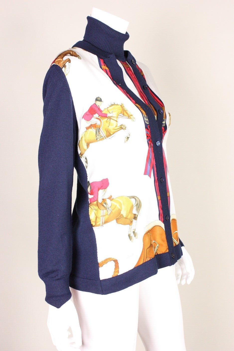 Hermes twinset is comprised of a turtleneck and cardigan.  Front is made of white silk with an equestrian print.  Backs of both pieces are made of finely woven knit wool.  Ribbed collar and cuffs.  Both items are new with tags.

Labeled size