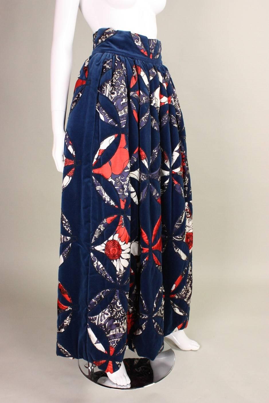 Vintage maxi skirt from Adolfo for Saks Fifth Avenue dates to the 1970's and is made of patchwork navy velvet.  Contrasting fabric features a graphic floral print.  Soutache trim along patchwork.  Wide waistband.  Fully lined.  Center back zippered