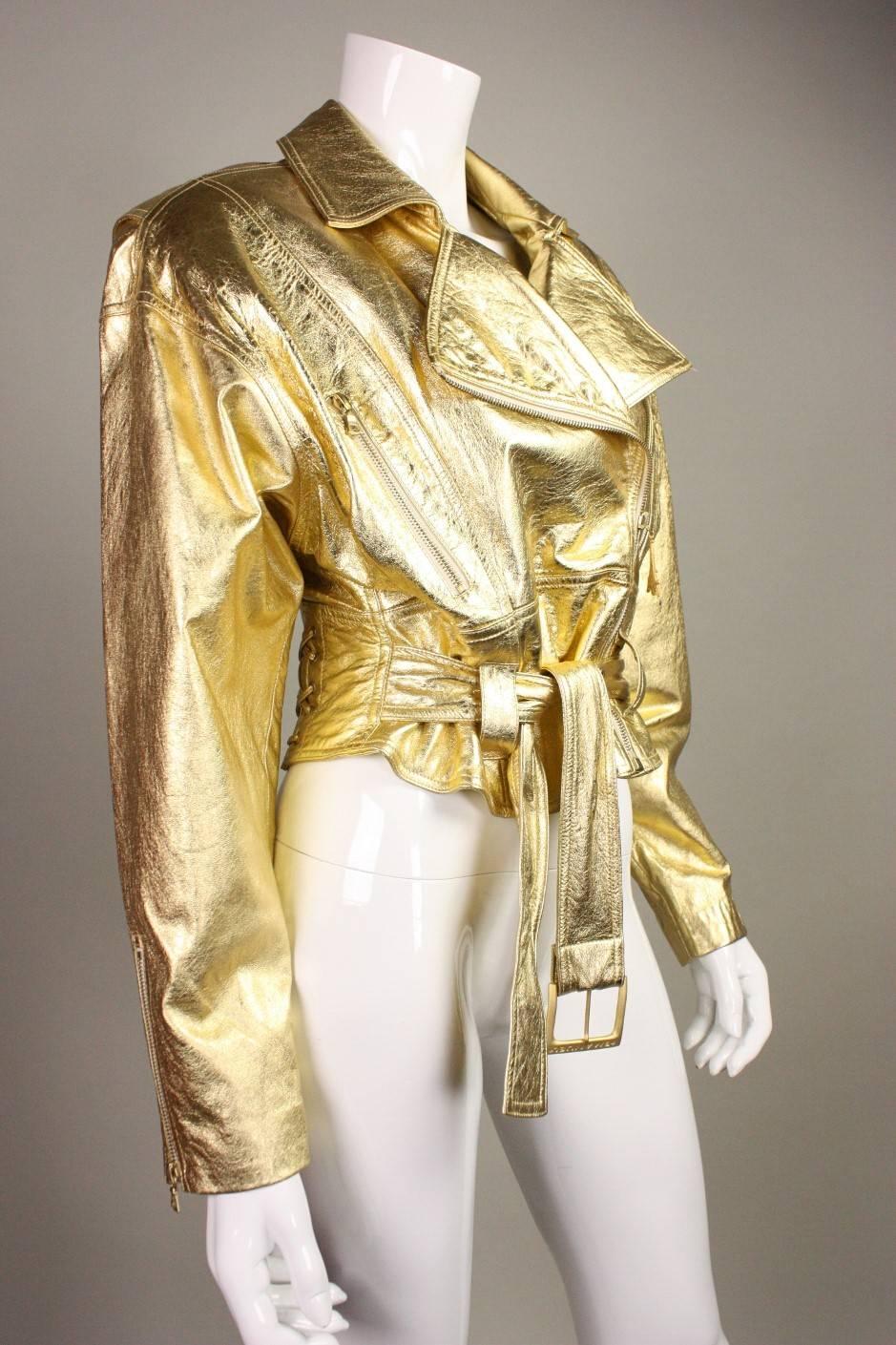 Vintage bomber from Emanuel Ungaro dates to the 1990's and is made of gold metallic leather.  Attached belt at waist with buckled closure.  Fabulous Eiffel Tower zipper pull.  Fully lined.

Labeled US size 6/ EU 40.

Measurements-

Bust: