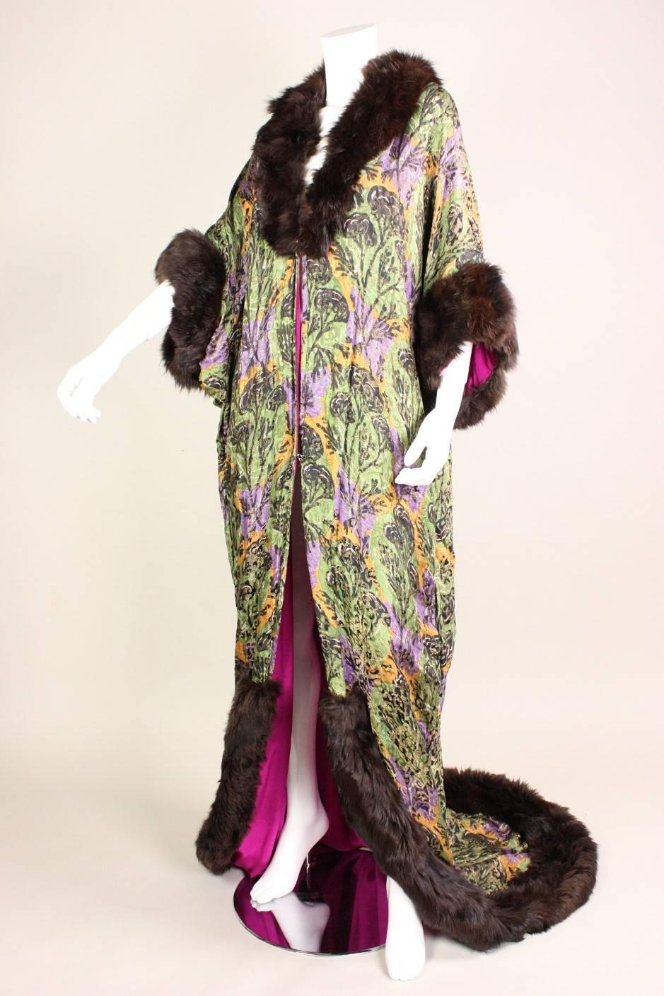 Vintage trained coat dates to the late Teens and is made of gorgeous gold lame fabric in tones of violet, orange, and green.  Luxurious dark brown fur trim at the collar, cuffs, and hem.  Fully lined.  Center front hook and eye closures.

Due to