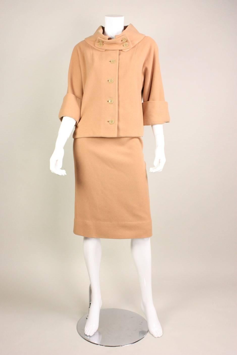 Vintage suit from Rudi Gernreich for Walter Bass dates to the 1950's and is made of camel-colored double-faced wool.  Single-breasted jacket features 3/4-length sleeves with wide cuffs.  Straight skirt has unusual curved seaming on the front