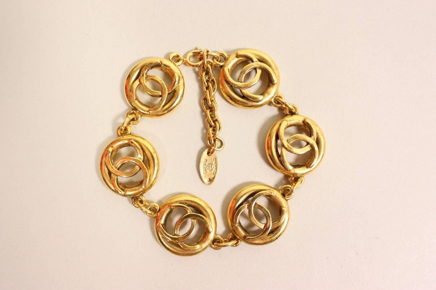 Vintage bracelet from Chanel dates to 1983 and is made of gold-toned metal in an interlocking C's pattern.  Adjustable length.