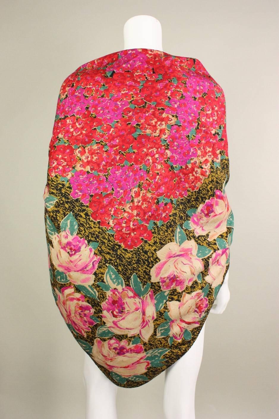 Vintage wool shawl from Emanuel Ungaro dates to the 1980's and is made of a lightweight wool with a bright floral print.  Rolled edges are hand-stitched.  Measures 54