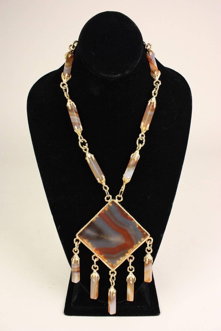 Vintage statement necklace dates to the 1970's and is made of gold-toned metal mixed with milky agate stones in varied neutral tones.  Long faceted agate beads are linked together.  Leaf motif in the metal.  Clasp is marked 