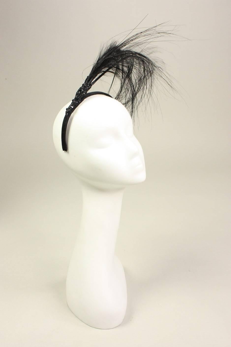 Fun and dramatic headpiece from Eric Javitz is made of a black velvet-covered headband.  Long curved plumes extend up and over the head.  Black glittery accent where the plumes meet the headband.