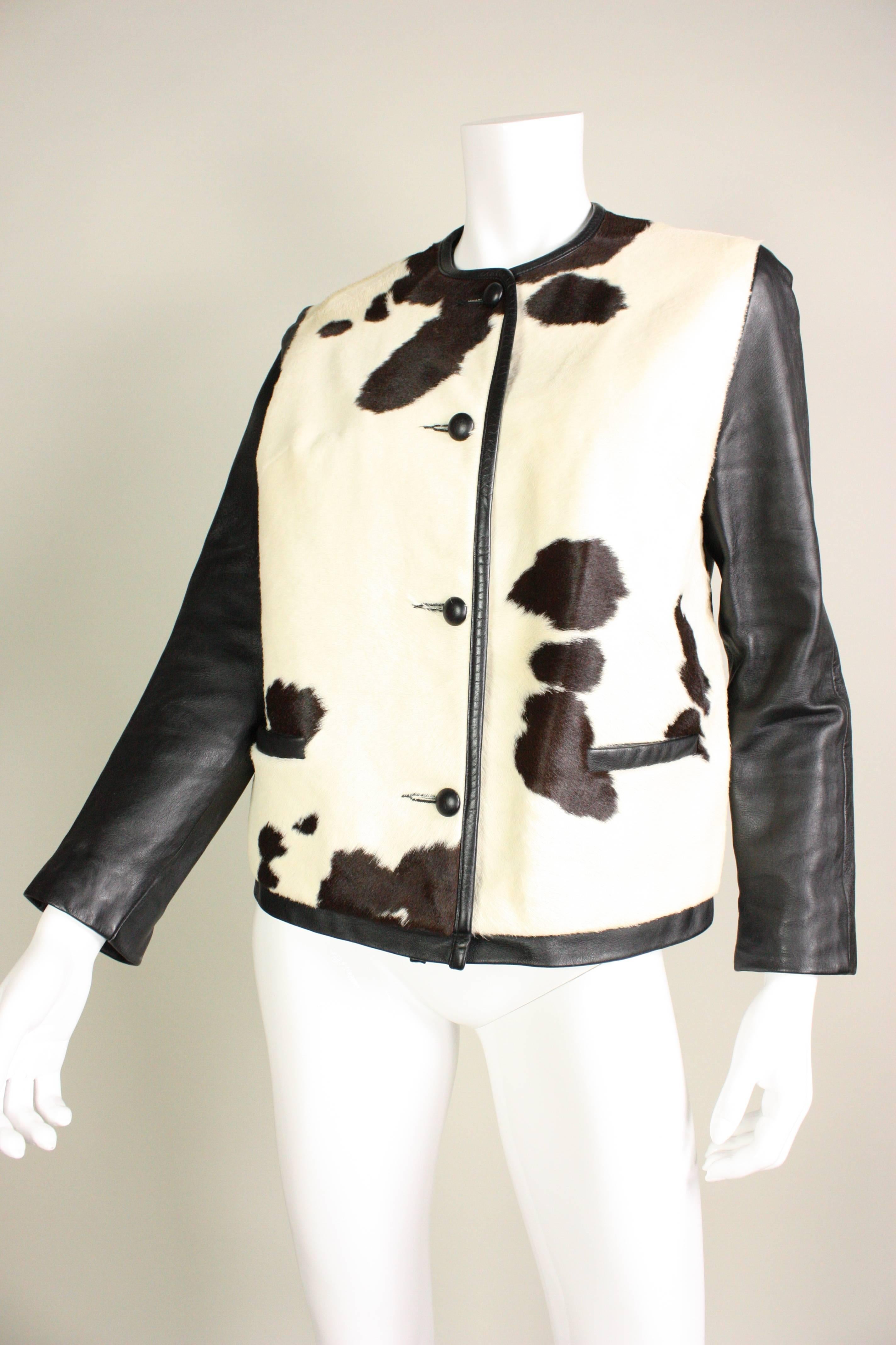 Vintage mod jacket dates to the 1960's and features a spotted cowhide front and black leather back and sleeves.  Black leather buttons and trim.  Fully lined.  Center front button closure.  Matching mini handbag.

Measurements-
Bust: 38
