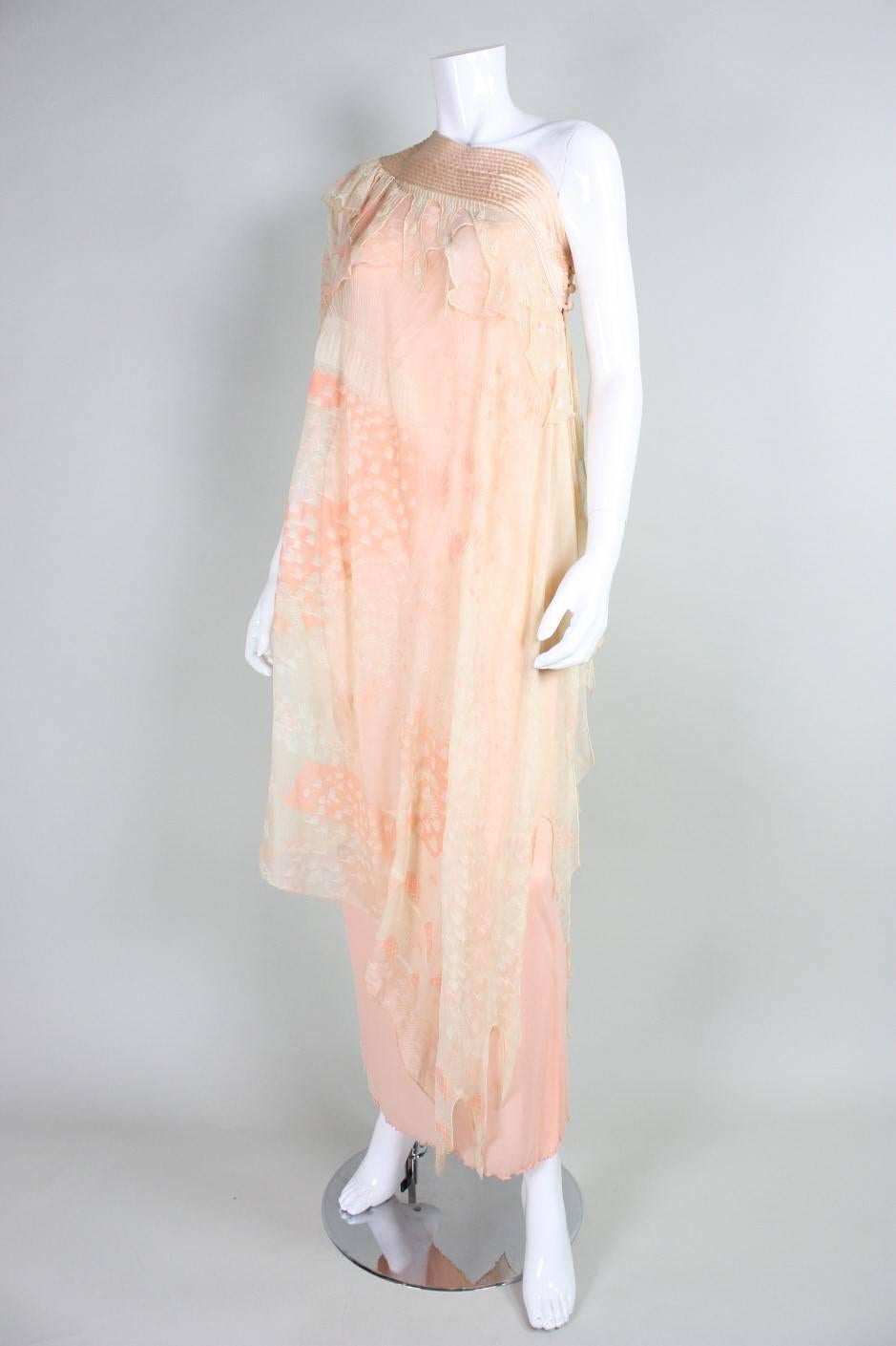 Vintage dress from Zandra Rhodes dates to the 1970's and is made of peach silk chiffon with an abstract pastel screenprint.  Underneath is a peach jersey sheath.  Wide satin band trims the top of the gown and features concentric stitching. Side