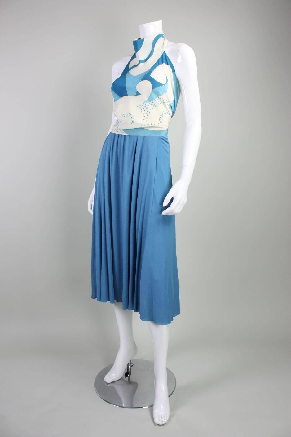 Vintage ensemble from Chloe dates to the 1970's and consists of a halter blouse and skirt.  Silk blouse features an abstract print and ties at neck and back waist. Below knee-length skirt is made of silk jersey, has zippered closure, and is lined.