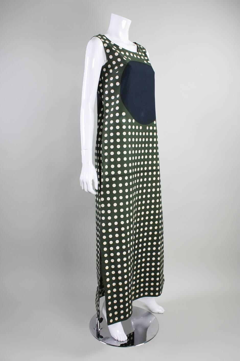 Vintage maxi dress from Marimekko dates to the 1960's and is made of olive green cotton with a white dot print.  Scoop neck.  Sleeveless.  Unlined.  No closures.  Hip pockets.  

Labeled a vintage size Medium.

Measurements-

Bust: 36"
Waist:
