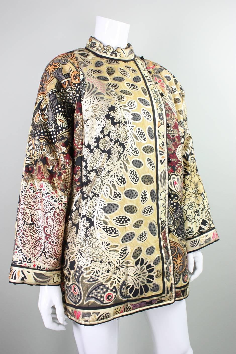 Vintage jacket from Leonard Paris dates to the 1980's and features an Asian motif.  Yellow fabric has a floral print in tones of orange and red with a gold screenprint. Asymmetrical looped button closure starts at side neck and extends vertically