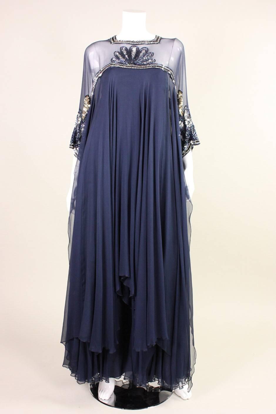 Vintage gown from Lesley Sandra dates to the 1970's and is made of layers of navy silk chiffon with a handkerchief hem.  Sequined and beaded detailing at front and back neckline and sleeves.  Fully lined.  Center back zipper.

Measurements-
Bust: