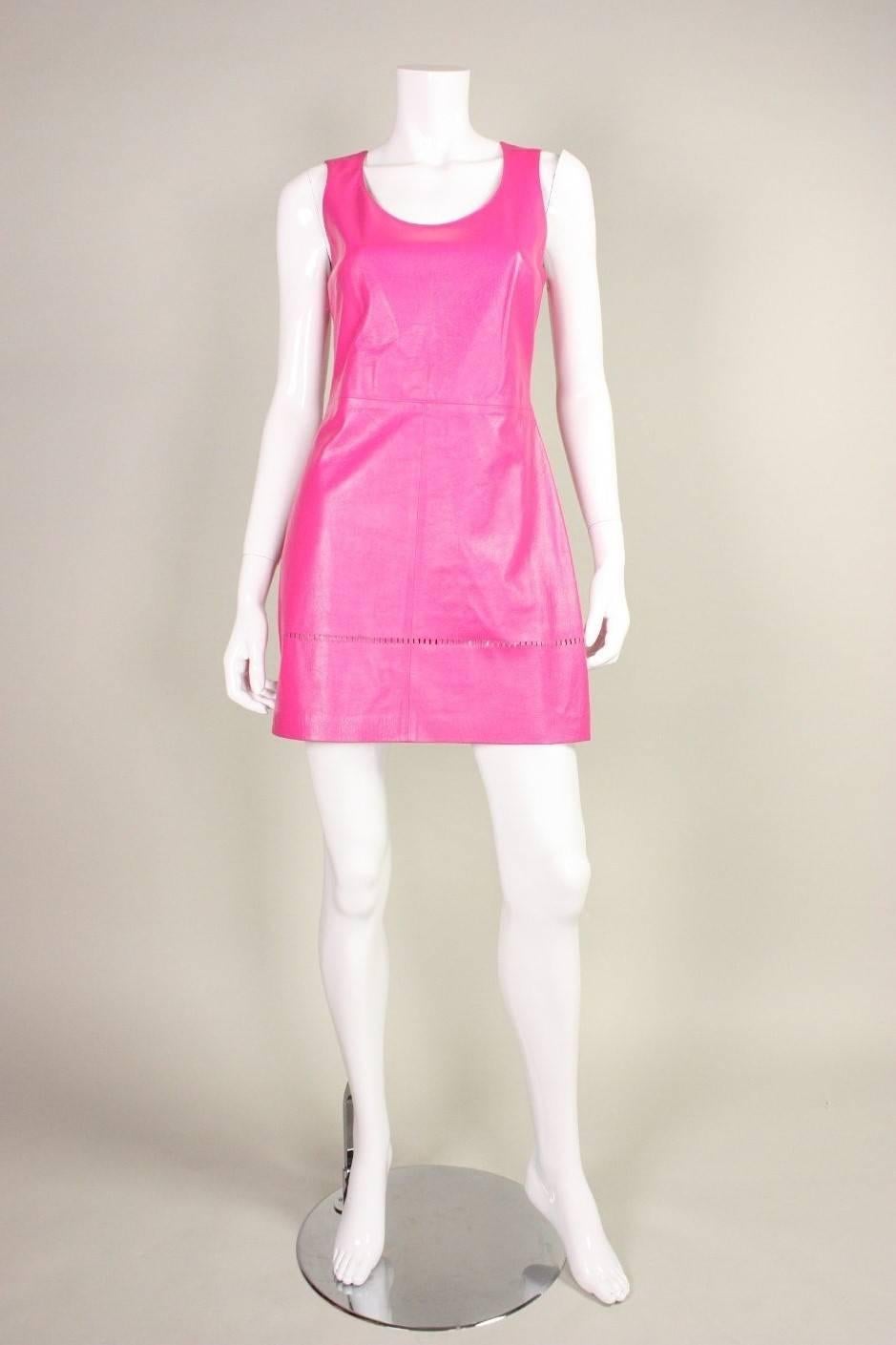 Vintage dress from Gianni Versace's Versus line is made of dark pink buttery-soft leather with perforation detailing at hem.  Scoop neck.  Sleeveless.  Fitted bodice.  A-line skirt.  

Labeled a vintage size 42, which would be best suited for a