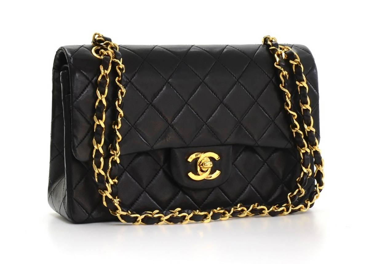 This ladies Chanel Small Classic Double Flap Bag is primarily made from black lambskin leather complimented by gold hardware. This bag is in excellent pre-owned condition with a small white mark on the bottom of the bag accompanied by Chanel dust