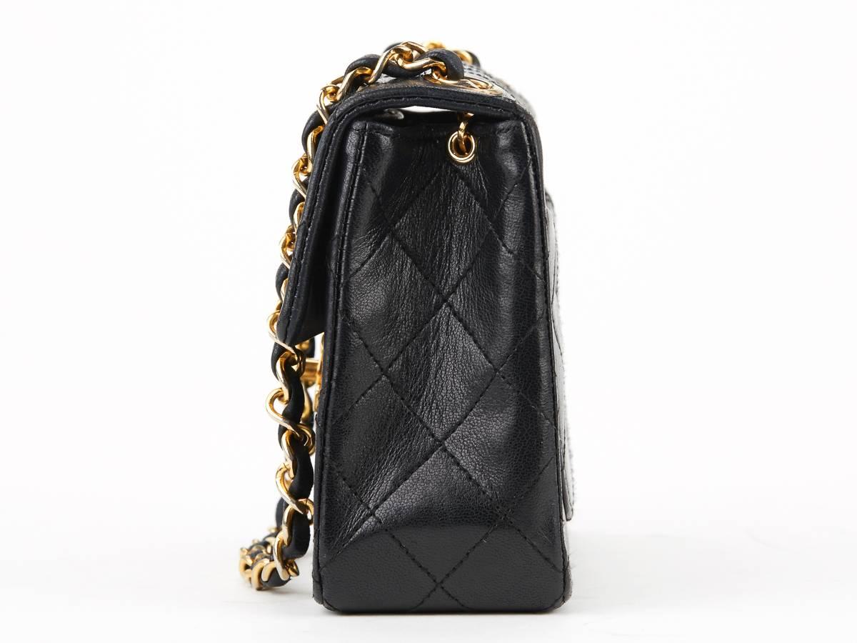 This ladies Chanel Mini Flap Bag is primarily made from black lambskin leather complimented by gold hardware. This bag is in very good pre-owned condition accompanied by Chanel dust bag. Circa 1988. Our  reference is HB203 should you need to quote