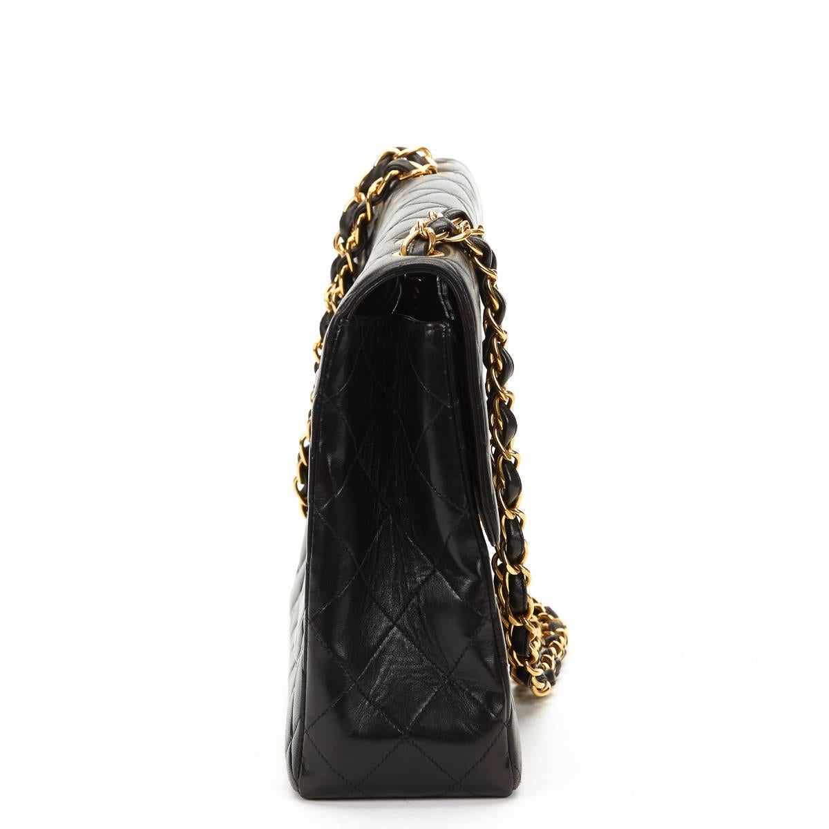 "CHANEL
Black Quilted Lambskin Vintage Jumbo XL Flap Bag

This CHANEL Jumbo XL Flap Bag is in Excellent Pre-Owned Condition. Circa 1996. Primarily made from Lambskin Leather complimented by Gold hardware. Our  reference is HB638 should you