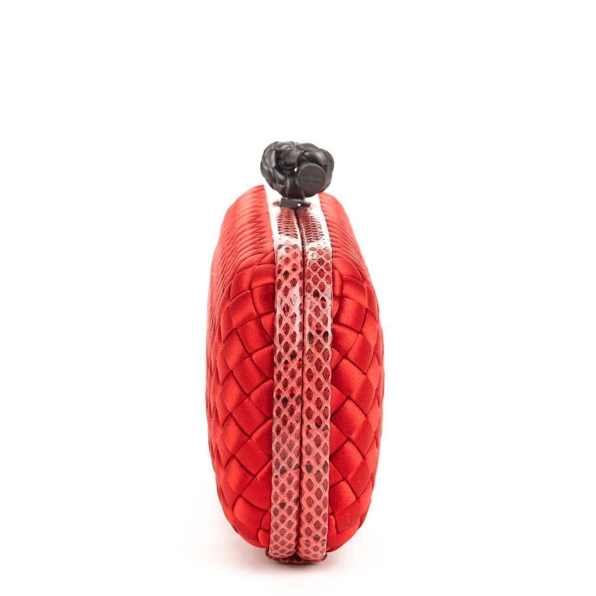 BOTTEGA VENETA
Red Woven Satin & Snakeskin Trim Long Knot Clutch

This BOTTEGA VENETA Long Knot Clutch is in Excellent Pre-Owned Condition accompanied by Care Card. Circa 2000. Primarily made from Satin complimented by Gunmetal hardware. Our 
