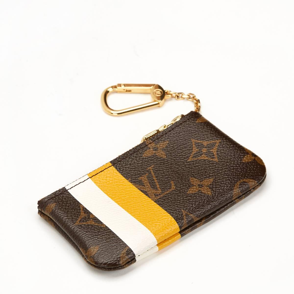 LOUIS VUITTON
Brown Classic Monogram Coated Canvas Groom Edition Key Pouch

This LOUIS VUITTON Key Pouch is in Excellent Pre-Owned Condition. Circa 2006. Primarily made from Coated Canvas complimented by Golden Brass hardware. Our  reference is