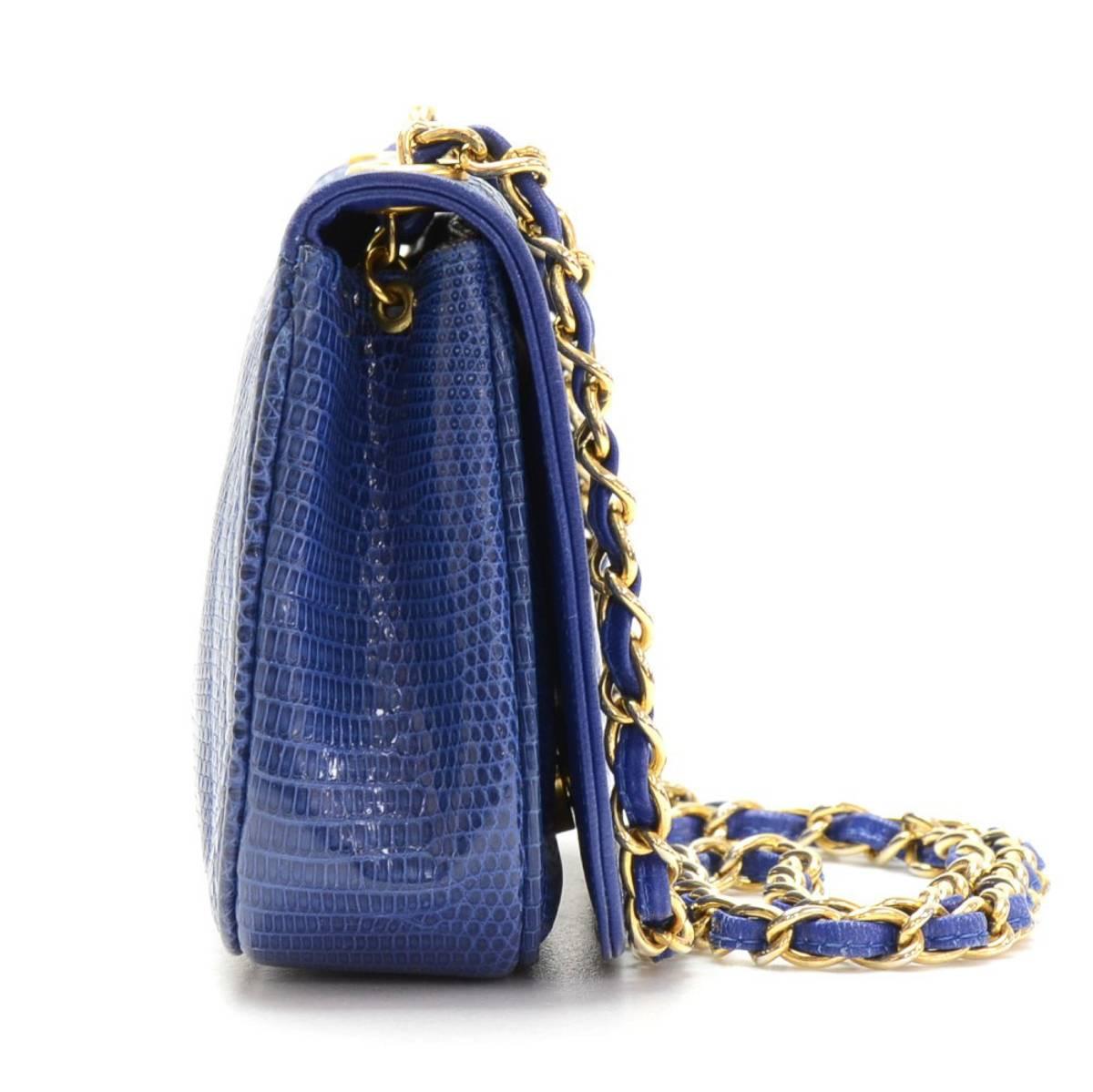 CHANEL
Blue Lizard Skin Vintage Mini Flap Bag

This CHANEL Mini Flap Bag is in Excellent Pre-Owned Condition accompanied by Authenticity Card. Circa 1997. Primarily made from Lizard Skin complimented by Gold hardware. Our  reference is HB241 should