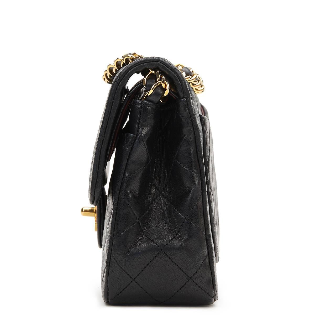 CHANEL
Black Quilted Lambskin Vintage Small Classic Double Flap Bag

This CHANEL Small Classic Double Flap Bag is in Very Good Pre-Owned Condition accompanied by Chanel Dust Bag, Box. Circa 1991. Primarily made from Lambskin Leather complimented by