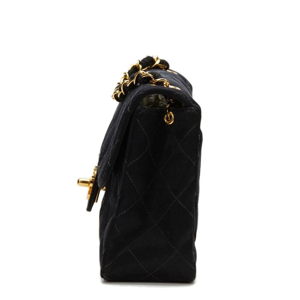 CHANEL
Black Satin Vintage Mini Flap Bag

This CHANEL Mini Flap Bag is in Excellent Pre-Owned Condition accompanied by Chanel Dust Bag, Box, Authenticity Card. Circa 1993. Primarily made from Satin complimented by Gold hardware. Our  reference is