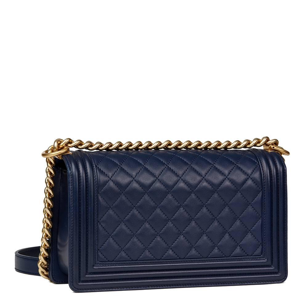 CHANEL
Navy Quilted Lambskin Medium Le Boy

This CHANEL Medium Le Boy is in Excellent Pre-Owned Condition accompanied by Chanel Dust Bag, Box, Care Booklet. Circa 2016. Primarily made from Lambskin Leather complimented by Antiqued Gold hardware. Our