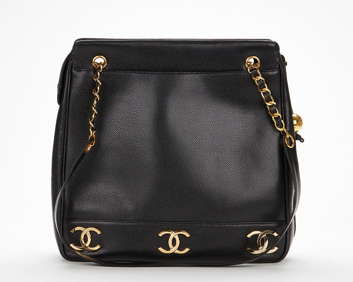 This Chanel Large CC Charm Shoulder Tote Bag is in excellent pre-owned condition accompanied by Chanel dust bag, authenticity card. Circa 1990's. Primarily made from Caviar Leather complimented by Gold hardware. Our  reference is HB040 should you