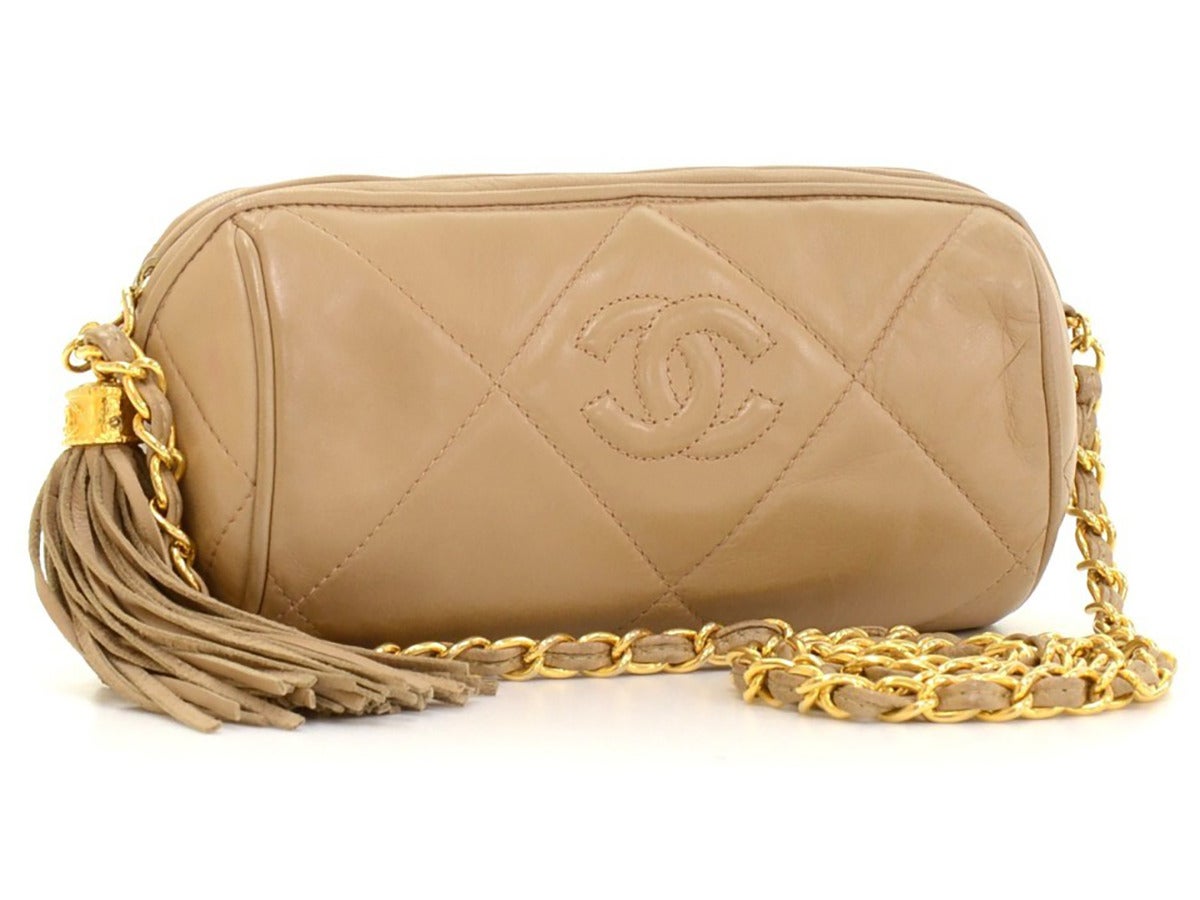 This Chanel Mini CC Logo Shoulder Fringe Tassel Bag is in excellent pre-owned condition accompanied by authenticity card. Circa 2000's. Primarily made from Lambskin Leather complimented by Gold hardware. Our  reference is HB041 should you need to