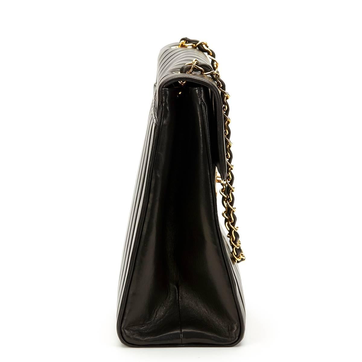 CHANEL
Black Vertical Quilted Lambskin Vintage Maxi Jumbo XXL Flap Bag

This CHANEL Maxi Jumbo XXL Flap Bag is in Excellent Pre-Owned Condition accompanied by Authenticity Card. Circa 1991. Primarily made from Lambskin Leather complimented by Gold