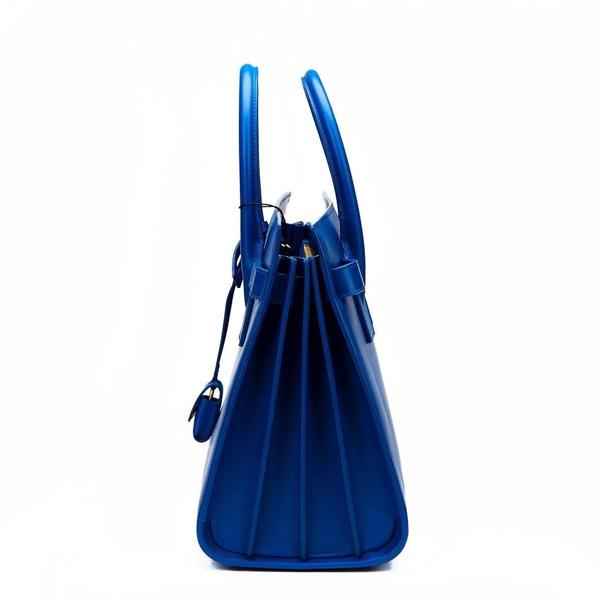 SAINT LAURENT
Royal Blue Calfskin Classic Small Sac De Jour

This SAINT LAURENT Small Sac De Jour is in Unworn Condition accompanied by Saint Laurent Dust Bag, Tags, Lock, Keys, Care Card, Shoulder Strap. Circa 2016. Primarily made from Calfskin