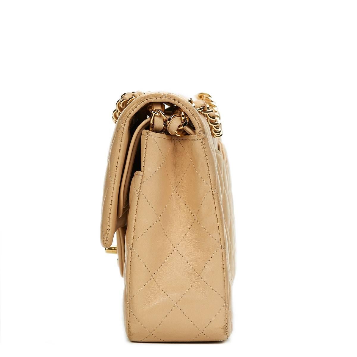 CHANEL
Beige Quilted Lambskin Classic Double Flap Bag

This CHANEL Medium Classic Double Flap Bag is in Excellent Pre-Owned Condition accompanied by Chanel Dust Bag, Authenticity Card, Box, Care Cards, Booklet. Circa 2012. Primarily made from