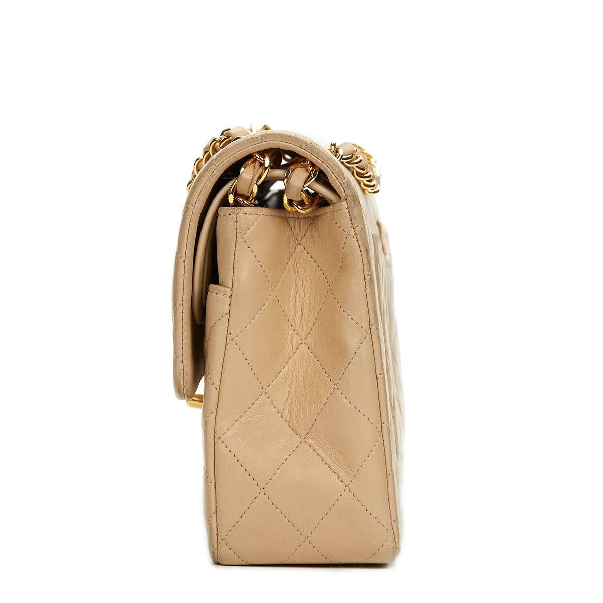 CHANEL
Beige Quilted Lambskin Vintage Medium Classic Double Flap Bag

This CHANEL Medium Classic Double Flap Bag is in Very Good Pre-Owned Condition accompanied by Chanel Dust Bag, Box, Authenticity Card. Circa 1994. Primarily made from Lambskin