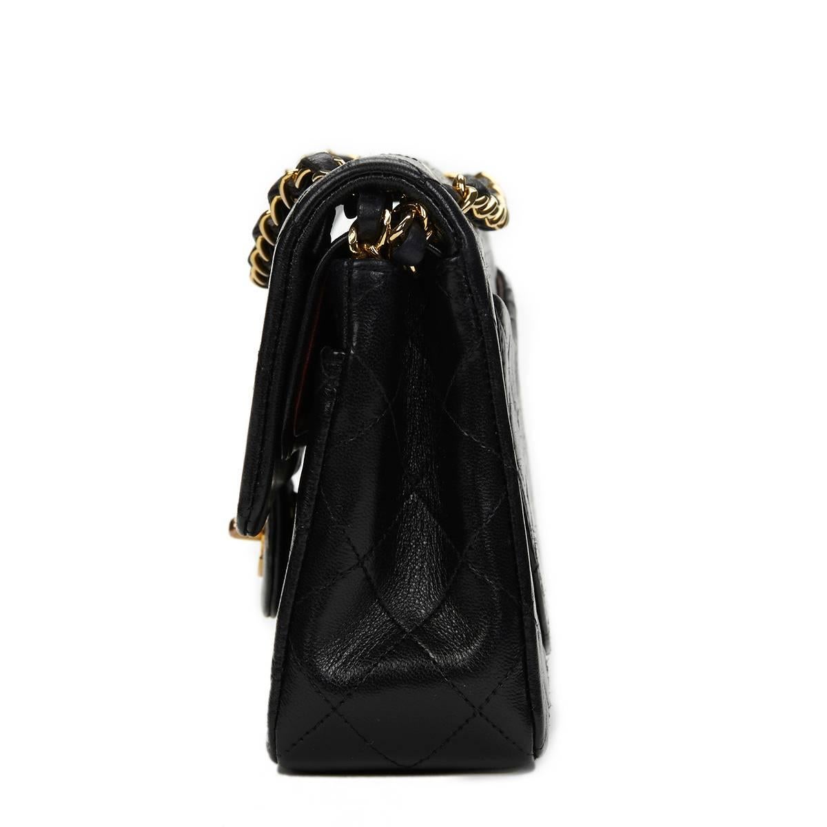 CHANEL
Black Quilted Lambskin Vintage Small Classic Double Flap Bag

 Reference: HB653
Serial Number: 1948478
Age (Circa): 1990
Authenticity Details: Serial Sticker (Made in France)
Gender: Ladies
Type: Shoulder

Colour: Black
Hardware: Gold (24k