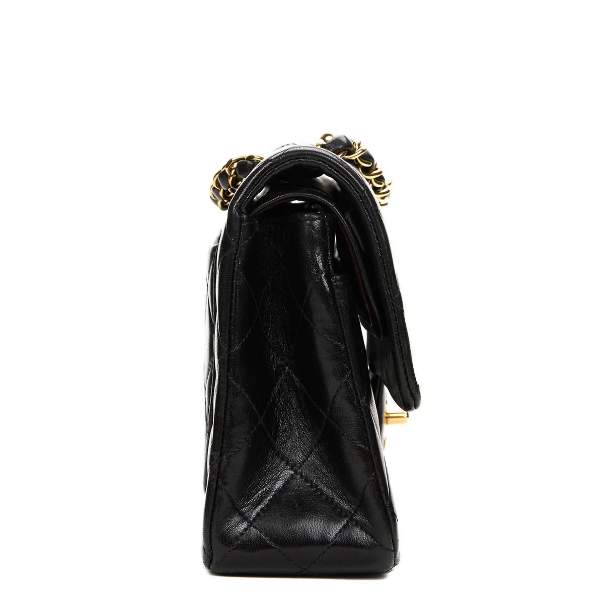 CHANEL
Black Quilted Lambskin Vintage Small Classic Double Flap Bag

This CHANEL Small Classic Double Flap Bag is in Excellent Pre-Owned Condition. Circa 1994. Primarily made from Lambskin Leather complimented by Gold hardware. Our  reference is
