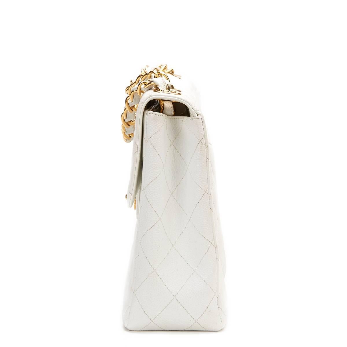 CHANEL
White Quilted Caviar Leather Vintage Jumbo Flap Bag

This CHANEL Jumbo Flap Bag is in Very Good Pre-Owned Condition accompanied by Chanel Dust Bag. Circa 1997. Primarily made from Caviar Leather complimented by Gold hardware. Our  reference