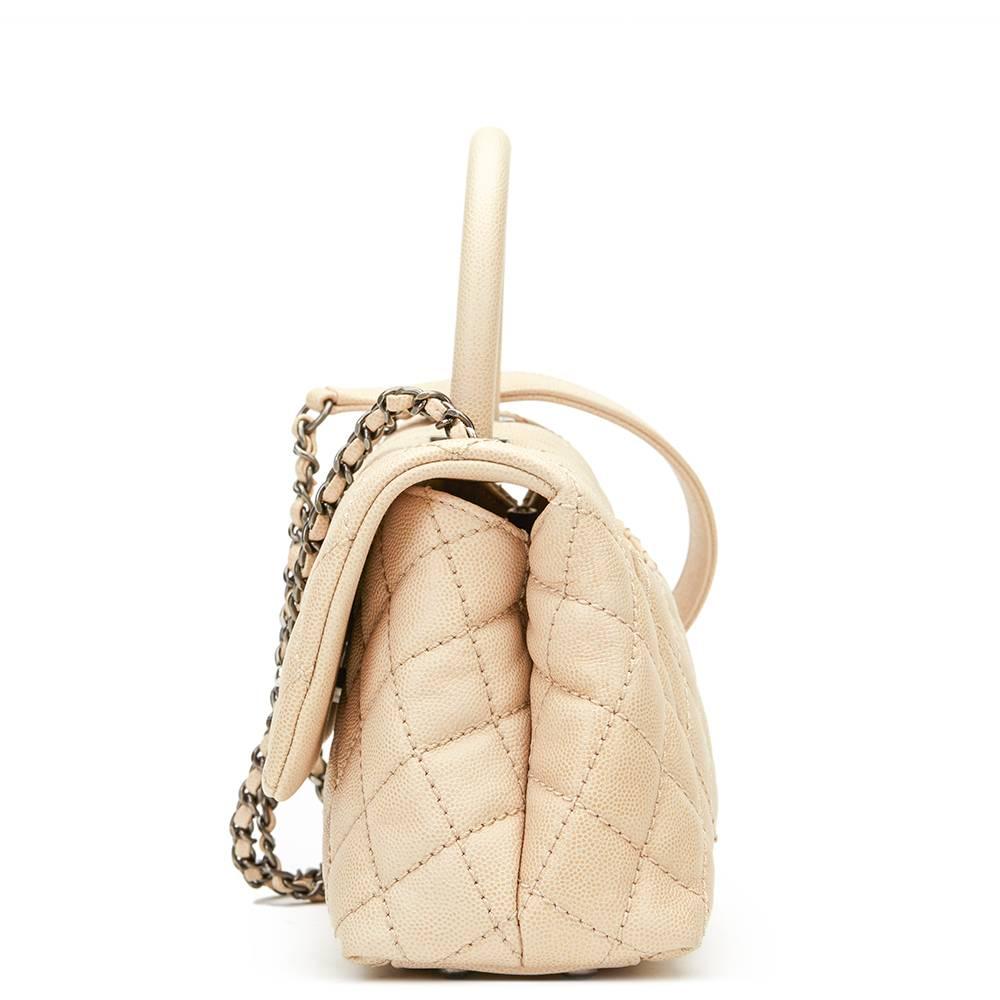 CHANEL
Beige Caviar Leather Mini Coco Handle

This CHANEL Mini Coco Handle is in Excellent Pre-Owned Condition accompanied by Chanel Dust Bag, Authenticity Card. Circa 2016. Primarily made from Caviar Leather complimented by Antiqued Silver