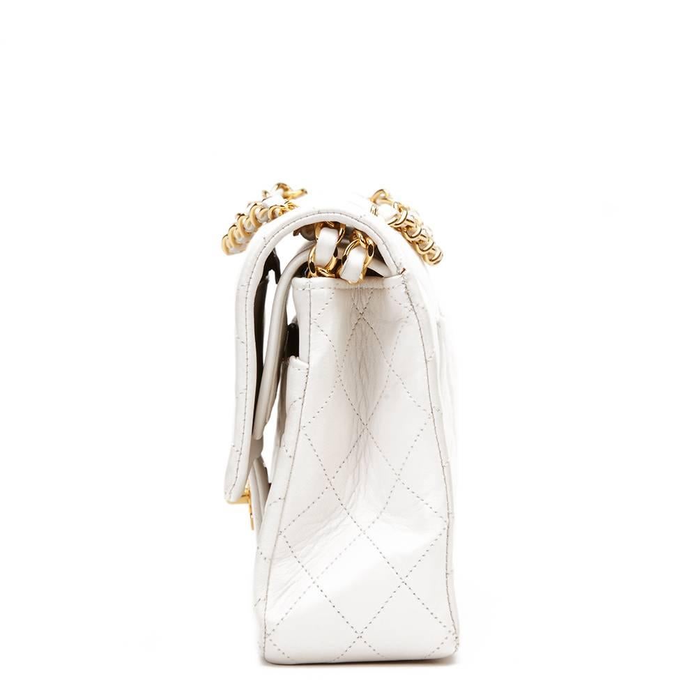 CHANEL
White Quilted Lambskin Vintage Medium Classic Double Flap Bag

This CHANEL Medium Classic Double Flap Bag is in Very Good Pre-Owned Condition accompanied by Chanel Dust Bag, Box, Authenticity Card. Circa 1991. Primarily made from Lambskin