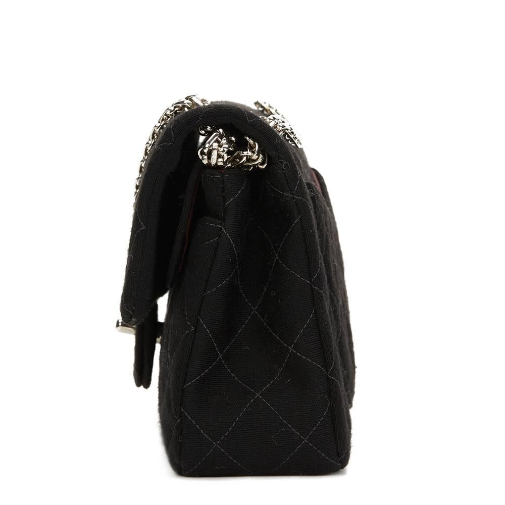 CHANEL
Black Quilted Fabric Small Classic Double Flap Bag

This CHANEL Medium Classic Double Flap Bag is in Excellent Pre-Owned Condition accompanied by Chanel Dust Bag, Box. Circa 1996. Primarily made from Fabric complimented by Silver hardware.