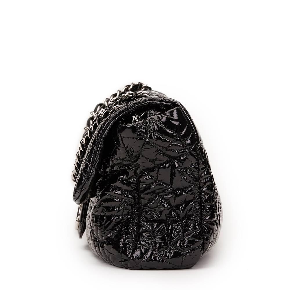 CHANEL
Black Graphic Edge Quilted Patent Vinyl Jumbo Flap Bag

This CHANEL Jumbo Flap Bag is in Very Good Pre-Owned Condition accompanied by Chanel Dust Bag, Authenticity Card. Circa 2006. Primarily made from Patent Vinyl complimented by Silver