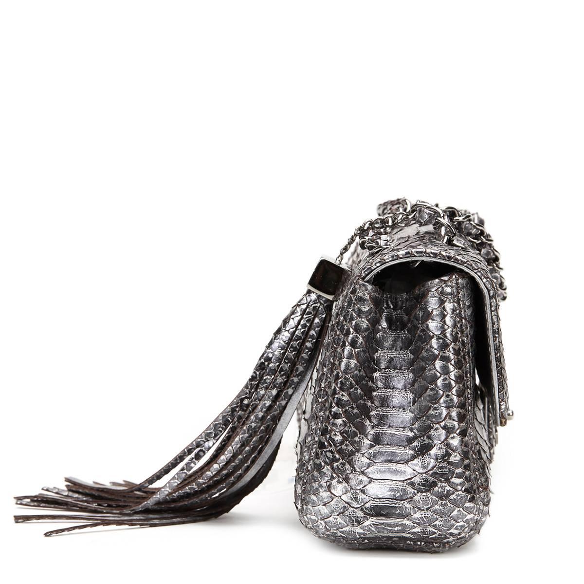 CHANEL
Metallic Silver Python Classic Single Flap Bag

This CHANEL Classic Single Flap Bag is in Excellent Pre-Owned Condition accompanied by Chanel Dust Bag, Authenticity Card. Circa 2007. Primarily made from Python complimented by Silver hardware.