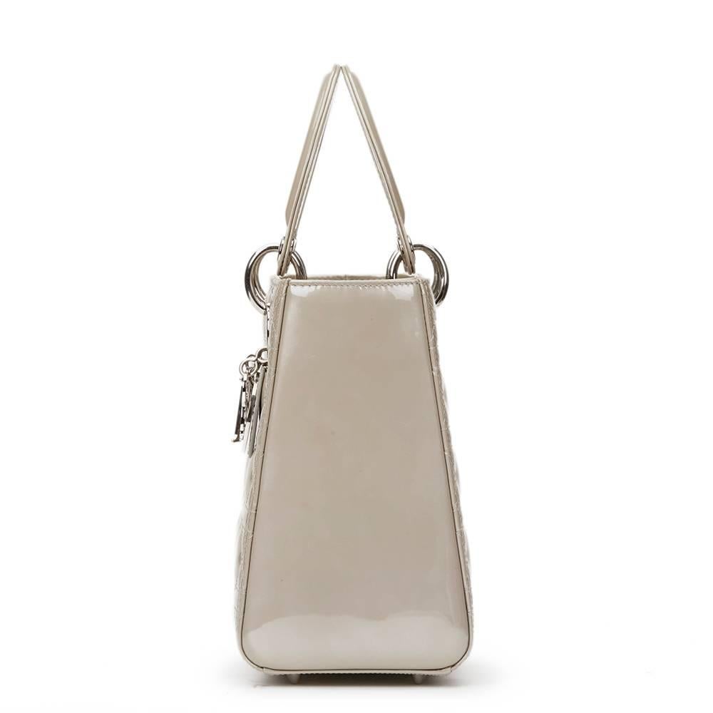 CHRISTIAN DIOR
Grey Pearlized Quilted Patent Leather Medium Lady Dior

This CHRISTIAN DIOR Medium Lady Dior is in Excellent Pre-Owned Condition accompanied by Dior Dust Bag, Authenticity Card, Care Booklet, 2 Shoulder Straps. Circa 2011. Primarily