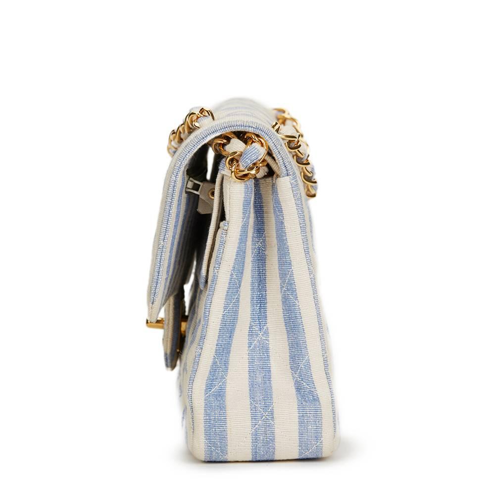 CHANEL
Ivory & Blue Striped Linen Vintage Small Classic Double Flap Bag

This CHANEL Small Classic Double Flap Bag is in Very Good Pre-Owned Condition. Circa 1990. Primarily made from Linen complimented by Gold (24k Plated) hardware. Our  reference