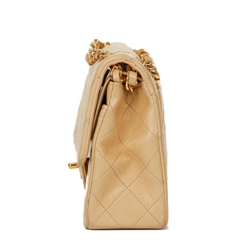 CHANEL
Beige Quilted Lambskin Vintage Small Classic Double Flap Bag

This CHANEL Small Classic Double Flap Bag is in Very Good Pre-Owned Condition accompanied by Authenticity Card. Circa 1993. Primarily made from Lambskin Leather complimented by