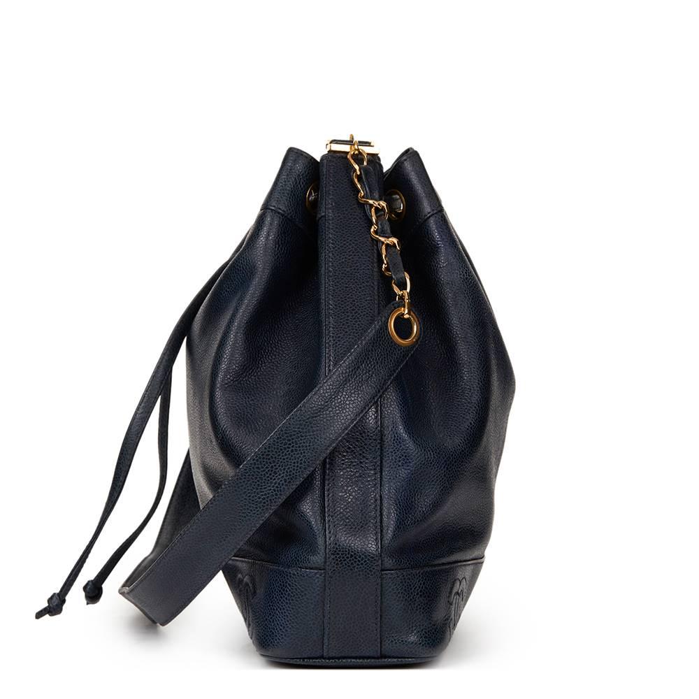 CHANEL
Navy Caviar Leather Vintage Bucket Bag

This CHANEL Bucket Bag is in Very Good Pre-Owned Condition accompanied by Chanel Dust Bag, Authenticity Card, Care Booklet, Interior Pouch. Circa 1995. Primarily made from Caviar Leather complimented by