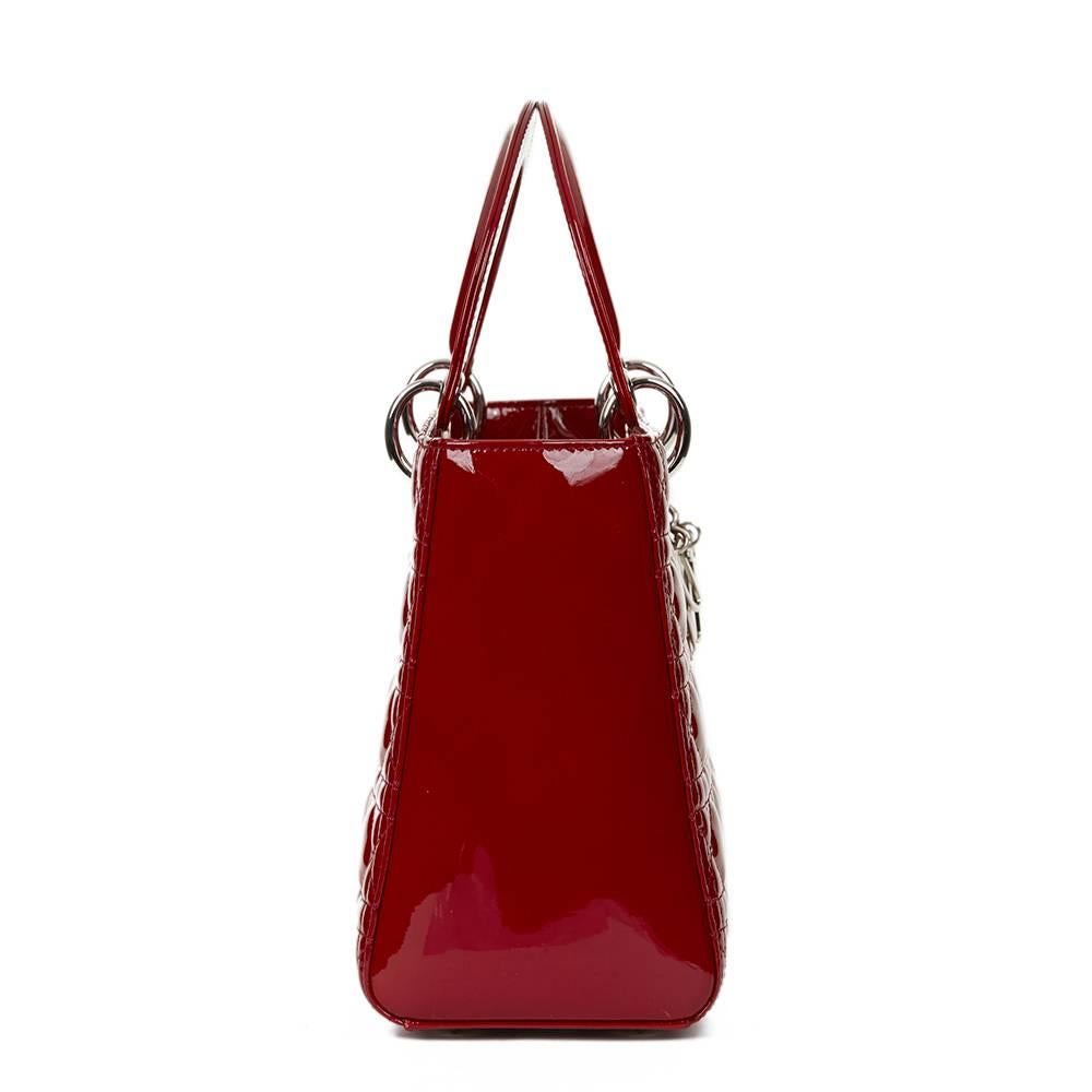 CHRISTIAN DIOR
Deep Red Quilted Patent Leather Medium Lady Dior

This CHRISTIAN DIOR Medium Lady Dior is in Excellent Pre-Owned Condition accompanied by Shoulder Strap. Circa 2014. Primarily made from Patent Leather complimented by Silver hardware.
