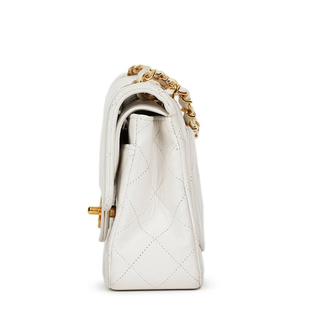 CHANEL
White Quilted Lambskin Vintage Small Classic Double Flap Bag

This CHANEL Small Classic Double Flap Bag is in Good Pre-Owned Condition accompanied by Chanel Dust Bag, Authenticity Card. Circa 1990. Primarily made from Lambskin Leather