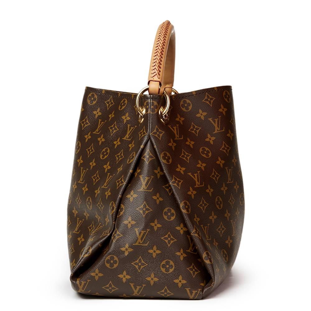LOUIS VUITTON
Brown Coated Monogram Canvas Artsy MM

This LOUIS VUITTON Artsy MM is in Excellent Pre-Owned Condition accompanied by Louis Vuitton Dust Bag. Circa 2013. Primarily made from Coated Canvas, Vachetta Leather complimented by Golden Brass