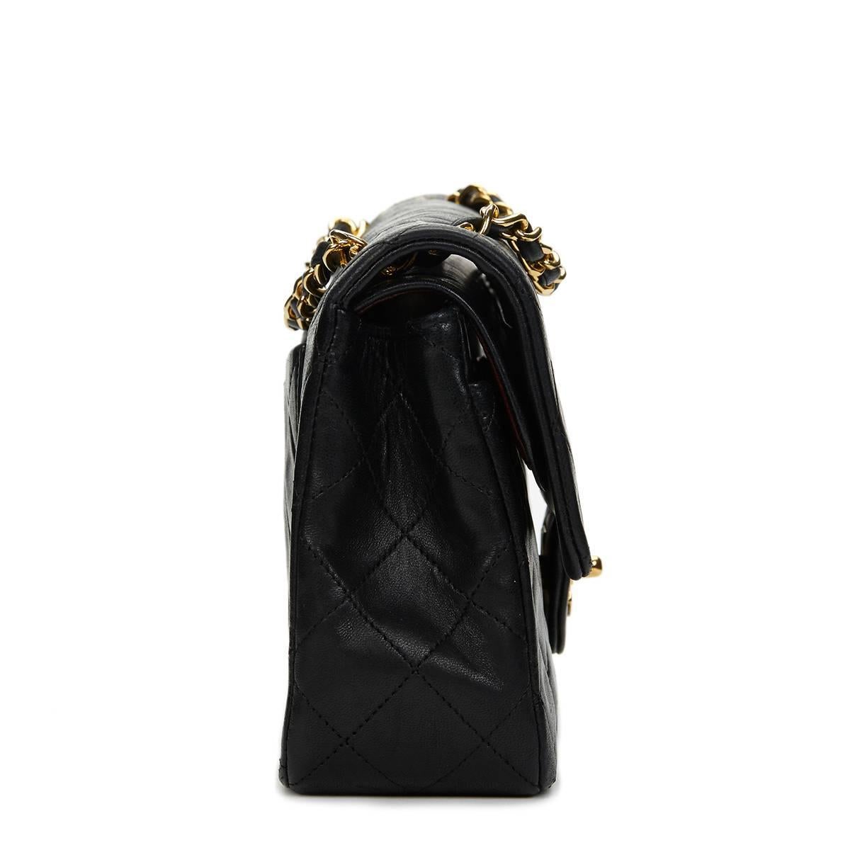 CHANEL
Black Quilted Lambskin Vintage Small Classic Double Flap Bag

This CHANEL Small Classic Double Flap Bag is in Excellent Pre-Owned Condition accompanied by Chanel Dust Bag. Circa 1991. Primarily made from Lambskin Leather complimented by Gold
