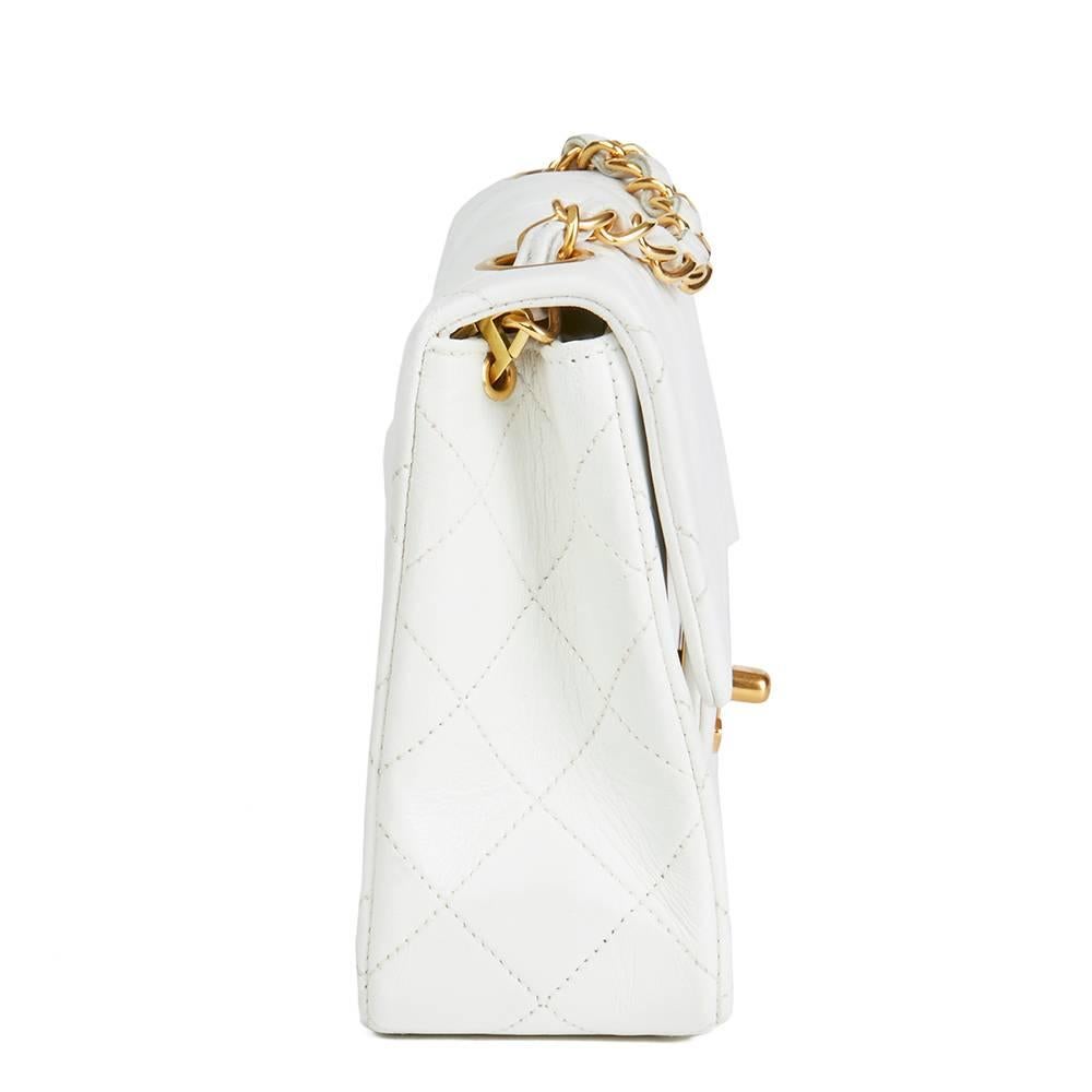 CHANEL
White Quilted Lambskin Vintage Mini Flap Bag

 Reference: HB1889
Serial Number: 2462620
Age (Circa): 1993
Accompanied By: Chanel Dust Bag, Authenticity Card
Authenticity Details: Authenticity Card, Serial Sticker (Made in France)
Gender:
